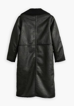 Black leather coat with a textured finish, featuring a black fur collar, long sleeves, and a straight cut with vertical seams.