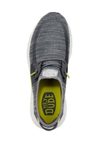 Sneaker grigi in maglia con suola bianca maculata, soletta gialla e lacci grigi. Presenta un'etichetta con il logo sulla linguetta.
