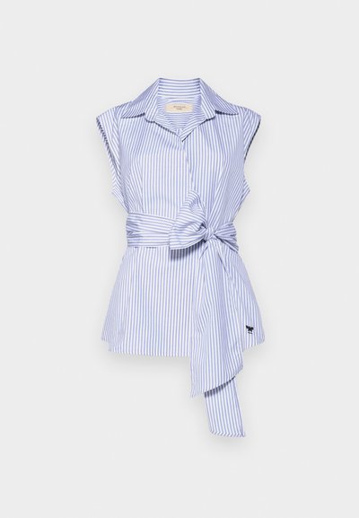 Blue and white striped sleeveless blouse with a collar, knotted waist detail, and a flared bottom hem. Features a small logo accent.
