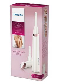 Stylo de retouche Philips Satin Compact en blanc avec des accents dorés rose. La boîte présente le produit et les accessoires, avec un branding rose et des images.