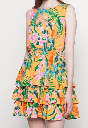 Sleeveless yellow dress with pink, orange, and green floral print, elastic waist, and tiered ruffle skirt worn by a standing person.