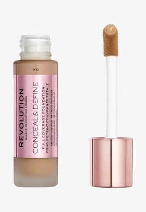 Revolution Conceal & Define Foundation in einer glasflasche mit mattem Finish und einem roségoldenen Deckel. Der Applikator hat eine weiche, flauschige Textur. Farbe F12.