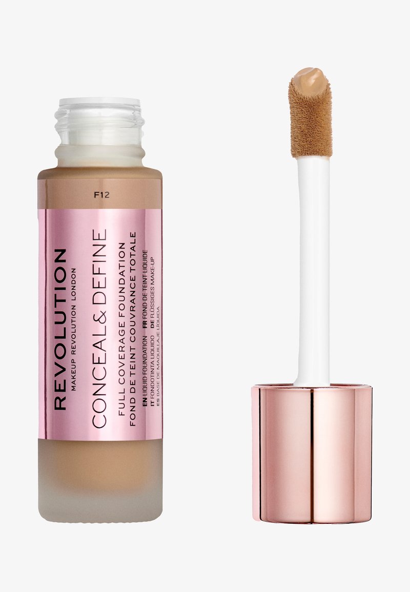 Revolution Conceal & Define foundation in a frosted glass bottle with a rose gold cap. The applicator has a soft, fluffy texture. Color F12.