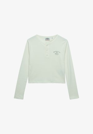 Kremowa koszulka henley z długim rękawem, trzema guzikami i małym napisem "New York State 1986 Athletics" na lewej piersi.