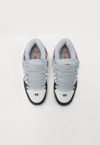 Gray fabric and black suede sneakers with red accents and white soles. Features thick laces and a padded collar for comfort.