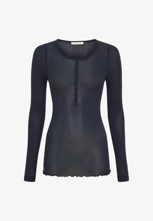 Navy long-sleeve top made of lightweight, sheer fabric. Features a crew neck, button closure, and scalloped hem.