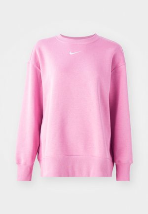 Sweatshirt rose en tissu doux, avec un col rond, des manches longues et un logo Nike blanc sur la poitrine. Poignets et ourlet côtelés.
