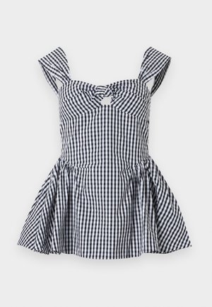 Robe sans manches en vichy noir et blanc avec larges bretelles, découpe nœud devant, taille cintrée et jupe évasée.