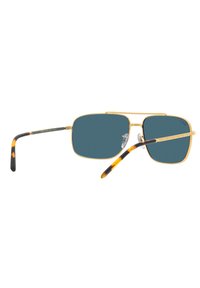 Occhiali da sole in metallo dorato con lenti blu rettangolari. Motivo tartaruga sulle punte delle tempie. Inclusi cuscinetti nasali regolabili.