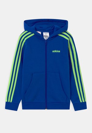 Felpa con cappuccio e zip blu con strisce verdi, cappuccio, tasche frontali e logo ricamato sul petto. Realizzata in tessuto morbido con polsini a costine.