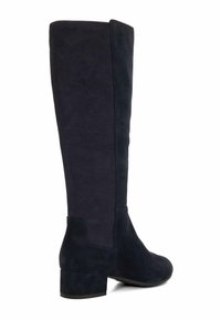 Tall navy blue suede boots with a flat block heel, smooth texture, and minimalistic design; side seam detailing visible.