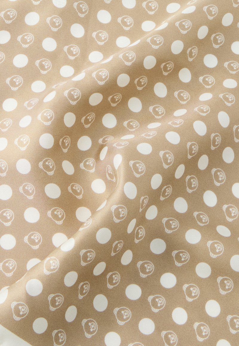 Brown patterned fabric featuring white polka dots and small bear faces, smooth texture with a slight sheen, folded to show depth.