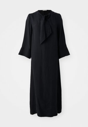 Black midi dress with a stand collar and a bowtie detail, long sleeves, and a relaxed fit, made from a smooth fabric with a matte finish.