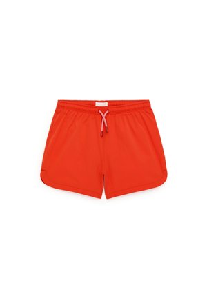 Short de bain rouge vif avec taille élastique et cordon blanc, tissu lisse, conçu pour une tenue décontractée ou sportive.