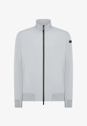 Giacca grigia chiara realizzata in tessuto liscio, con colletto alto, zip centrale, tasche laterali e un accento nero sulla manica.