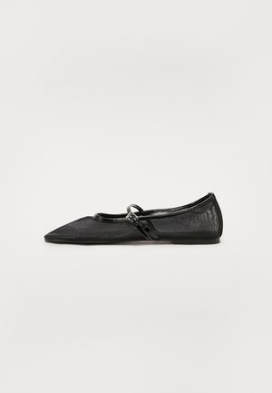 Black flat shoe with pointed toe, mesh upper, and patent leather accents. Features a thin strap with a circular hardware detail.