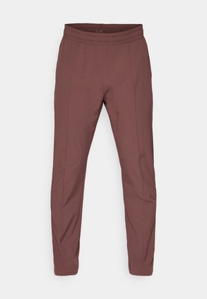 Maroon trousers with an elastic waistband, tapered fit, smooth texture, and subtle side seam details. Simple design, no additional accents.