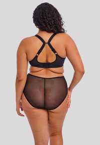 Ensemble de lingerie noire comprenant un soutien-gorge à dos croisillon avec bretelles réglables, associé à un shorty taille haute semi-transparent.