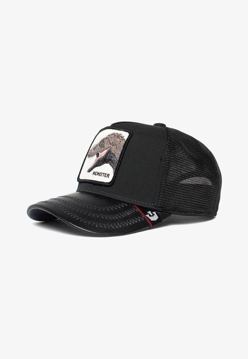 Black baseball cap with mesh sides, featuring a front patch of a monster's head. Stitch detailing on the brim, and a logo on the side.