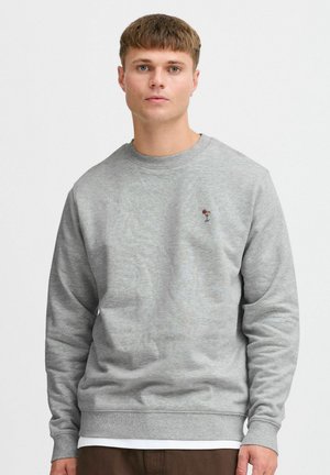 Gray sweatshirt made of soft fabric, featuring a classic crew neck and small embroidered design on the left chest. Long sleeves and relaxed fit.