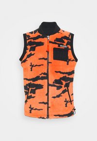 Orange fleece vest with black camouflage pattern, zip closure, high collar, and a front chest pocket. Features a zippered side pocket.
