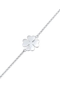 Pulsera de plata con un charm de trébol de cuatro hojas. Acabado suave y pulido, eslabones de cadena y estampada con "925" para autenticar la plata de ley.