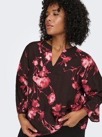 Dark brown loose-fit blouse featuring red floral print, long sleeves, a V-neckline, and a front pocket with a textured fabric.
