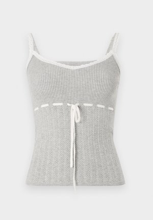 Gray ribbed tank top with lace trim, featuring a v-neckline, tie detail at the waist, and a texture resembling a knitted pattern.