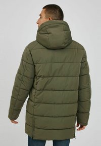 Olive green padded jacket with a large hood, quilted design, and a straight cut. Features a zipper at the bottom hem and side pockets.
