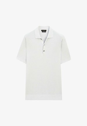 Polo shirt grigio chiaro a maniche corte con colletto, placket con due bottoni e orlo a coste. Realizzato in un tessuto a maglia testurizzato.