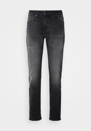 Jeans de ganga pretos com um ajuste de perna reta. Apresentam um fecho de botão e fecho éclair, cinco bolsos e descoloração subtil no tecido.