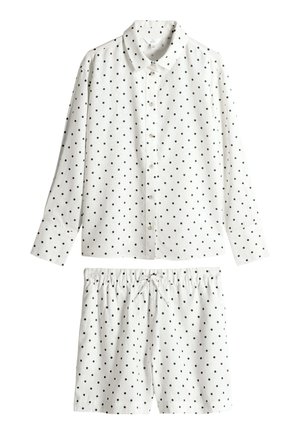 Balta pidžamas komplekts ar melniem punktiņiem. Garām piedurknēm ar pogām uz priekšu krekls un šorti ar elastīgu jostasvietu. Kokvilnas materiāls, gluda tekstūra.