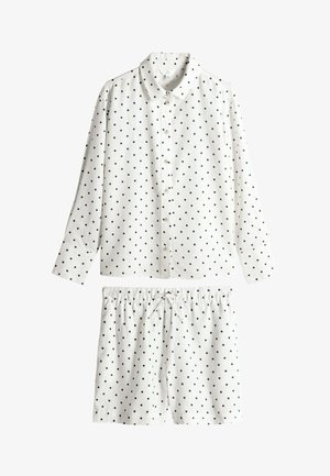 Bijeli komplet pidžame s crnim točkicama. Košulja s dugim rukavima i gumbima te kratke hlače s elastičnim strukom. Pamuk, glatka tekstura.
