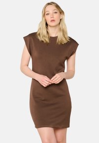 Abito mini senza maniche di colore marrone, realizzato in morbido misto cotone, con una vestibilità rilassata, scollatura rotonda e dettagli dei bottoni sulle spalle.