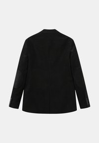 Blazer noir avec une texture lisse, des revers notés et des patchs aux coudes. Comprend des poignets boutonnés et une fente unique à l'arrière.