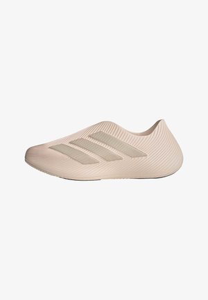 Beigen värinen slip-on-urheilukenkä, jossa on teksturoitu pinta ja kolme rinnakkaista raitaa sivussa, ei nauhoja, vasemman profiilin näkymä.