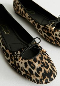 Leopard print flat shoes with a rounded toe, black trim, bow detail, and gold accents on the lace. Smooth fabric surface, lightweight design.
