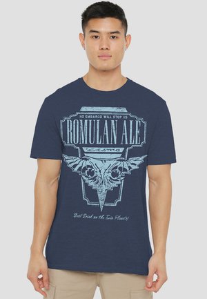 Navy blue cotton t-shirt featuring a graphic print with “Romulan Ale” text and a bat-like emblem in light blue. Short sleeves, round neck.