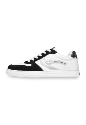 Low-top sneaker with white leather, black suede overlays, silver accent, white laces, and a white rubber sole, shown in side profile.