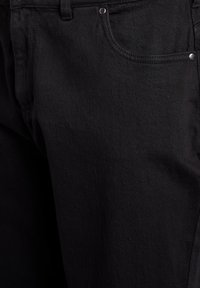 Black denim jeans with a classic five-pocket design, featuring silver hardware and a textured fabric for durability.