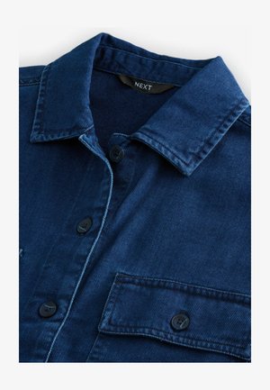 Dark blue denim shirt featuring a classic collar, front button closure, and two chest pockets with black buttons and tonal stitching.