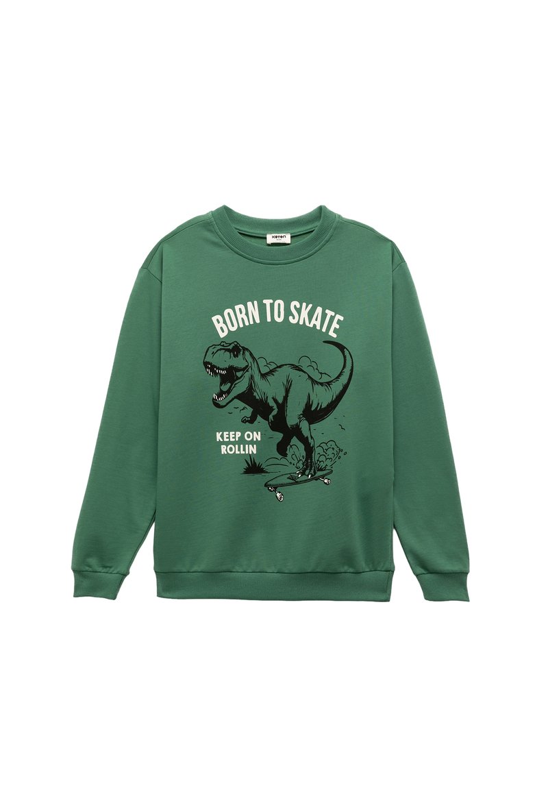 Groene sweat, gemaakt van katoen, met een dinosaurustekening en de teksten "Born to Skate" en "Keep on Rollin" in zwart-wit.