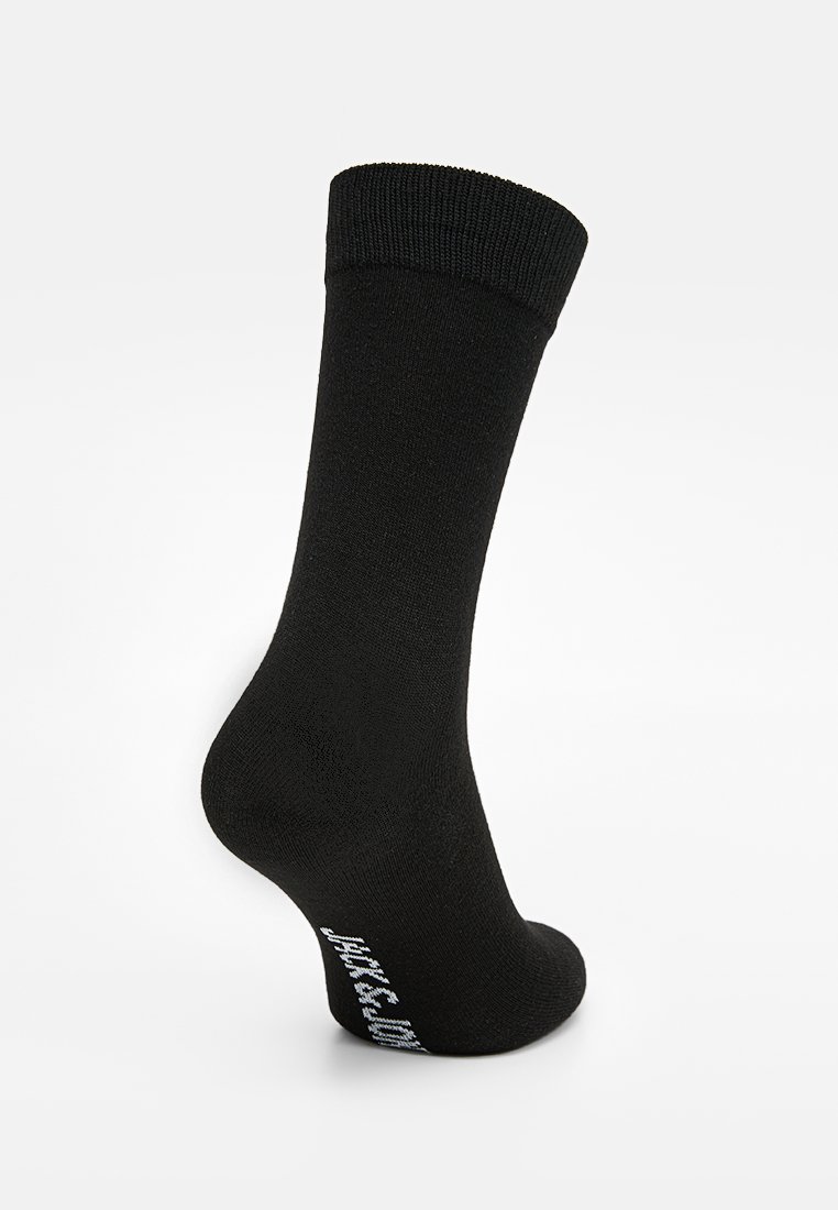Calcetín de algodón negro con puño acanalado, textura suave y logo impreso en el lateral. Diseñado para un ajuste ceñido y cómodo.