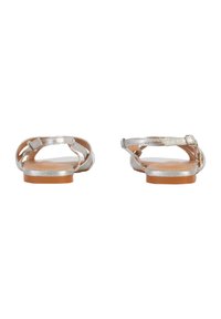Silver flat sandals with a textured strap design, adjustable buckles, and a tan rubber sole. The sandals feature open backs for easy wear.