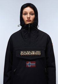 Black hooded jacket featuring a front flap with "NAPAPIJRI" branding and a Norwegian flag patch. Textured fabric and adjustable hood.