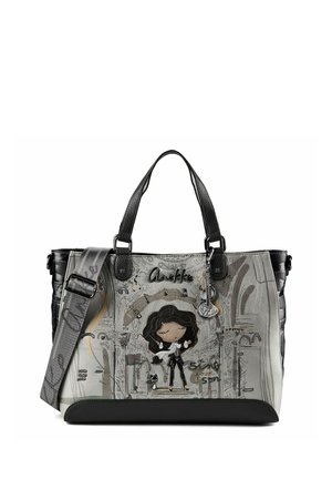 Borsa grigia e nera con design di donna e cane in stile cartone animato, manici neri e tracolla grigia regolabile con accenti di testo.