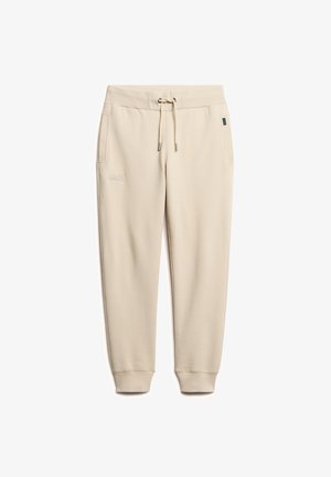 Beige sweatpants van zacht materiaal, voorzien van een elastische tailleband met koord, zijzakken en geribbelde boorden. Subtiel logo-detail op de dij.