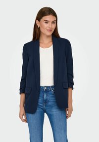Marine blazer med skræddersyet design, åben forrest og opsmøget ærmer. Har to forlommer og et glat, tekstureret stof.