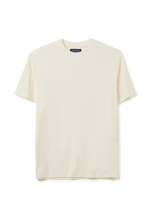 Cremfarbener Baumwoll-T-Shirt mit Rundhalsausschnitt und kurzen Ärmeln. Schlichtes Design, weiche Textur und gerader Schnitt. Etikett am Halsausschnitt sichtbar.
