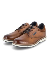 Chaussures en cuir marron avec une finition lisse, bout arrondi et semelles en caoutchouc blanc contrastant. Présentent des lacets noirs et un petit détail de logo.